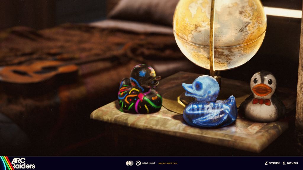 Three community-designed rubber ducks beside a globe, with neon, skeleton, and penguin designs